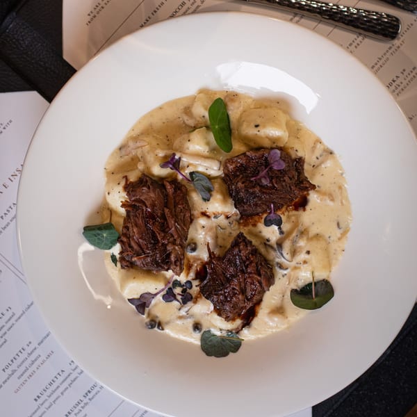 Ovest Via's Italian gnocchi with braised short rib, creamy sauce, and fresh herbs.